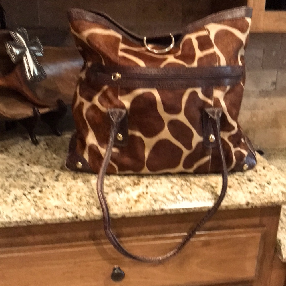 Genuine hair leather. Made in Italy. 18 x 16x5 .Animal design on hair.